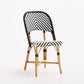 French bistro chair with black and white woven rattan chevron pattern and natural wooden frame on white background.