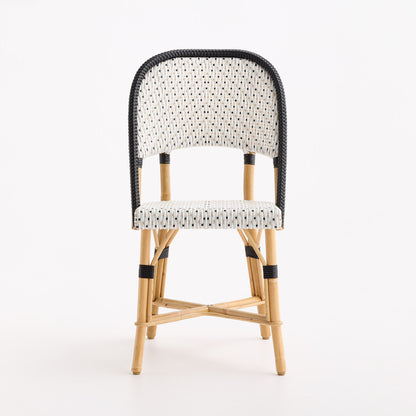 Maison Drucker French bistro chair with black and white polka dot woven rattan seat and back on a natural wooden frame.