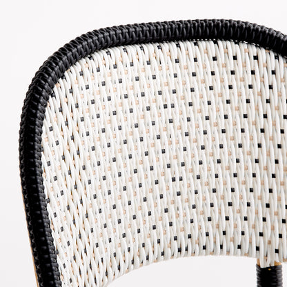 French bistro chair backrest with black and white woven rattan in a polka dot pattern and a solid black border.