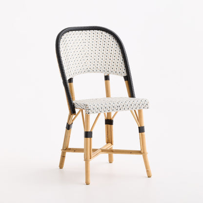 French bistro chair with black and white polka dot woven rattan seat and backrest on a natural wooden frame.
