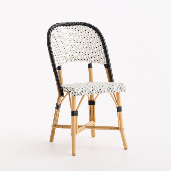 French bistro chair with black and white polka dot woven rattan seat and backrest on a natural wooden frame.