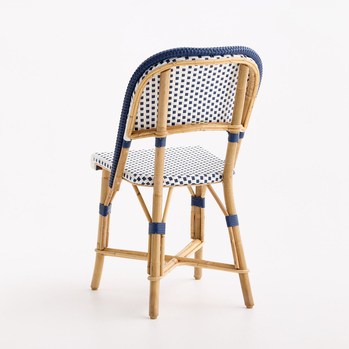 French bistro chair in natural rattan with blue and white polka dot woven seat and backrest and blue border detailing.