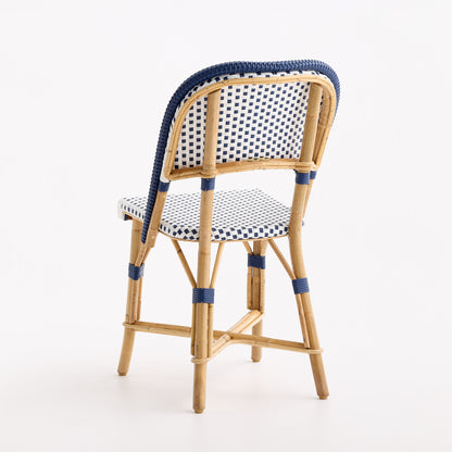 French bistro chair in natural rattan with blue and white polka dot woven seat and backrest and blue border detailing.