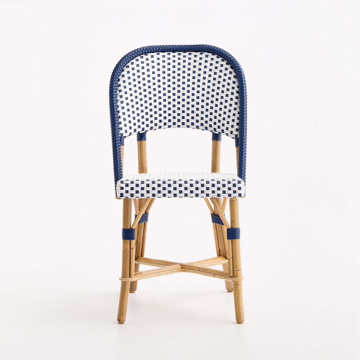 French bistro chair with blue and white polka dot woven rattan, wooden frame, and blue border detail.