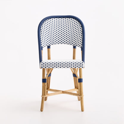 French bistro chair with blue and white polka dot woven rattan, wooden frame, and blue border detail.