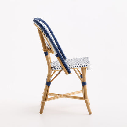 French bistro chair with blue and white polka dot woven rattan seat and back on a natural wooden frame.