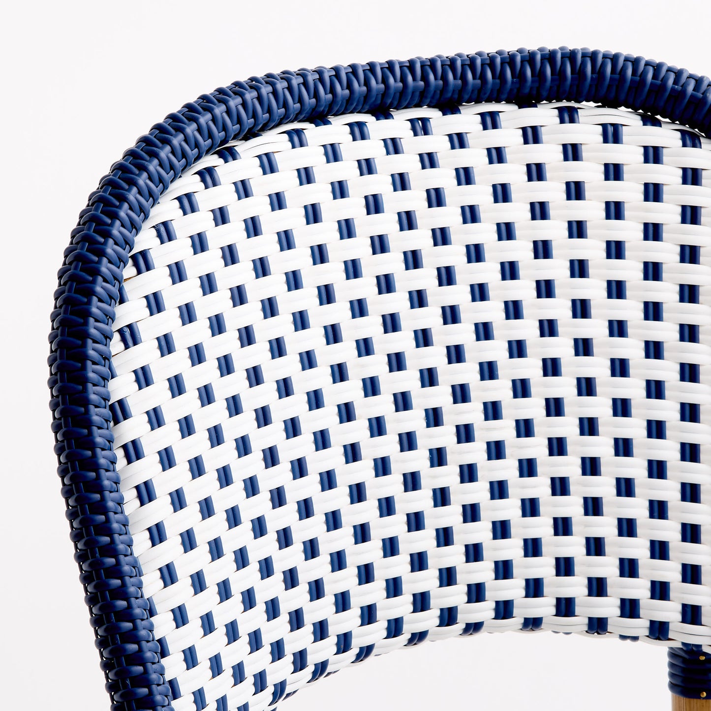 Blue and white woven rattan bistro chair back with a polka dot pattern and solid blue border.