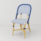 Rattan Chambord Blue Polka Dot Bistro Chair with blue and white woven rattan and a natural wooden frame.