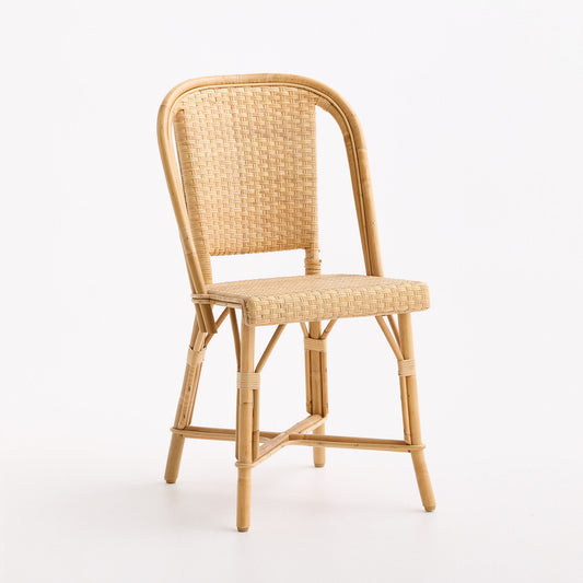 French Parisian bistro chair in natural woven rattan with a light wood frame and curved backrest.