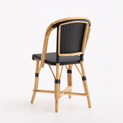 French bistro chair with a natural rattan frame and black woven seat and backrest on a white background.