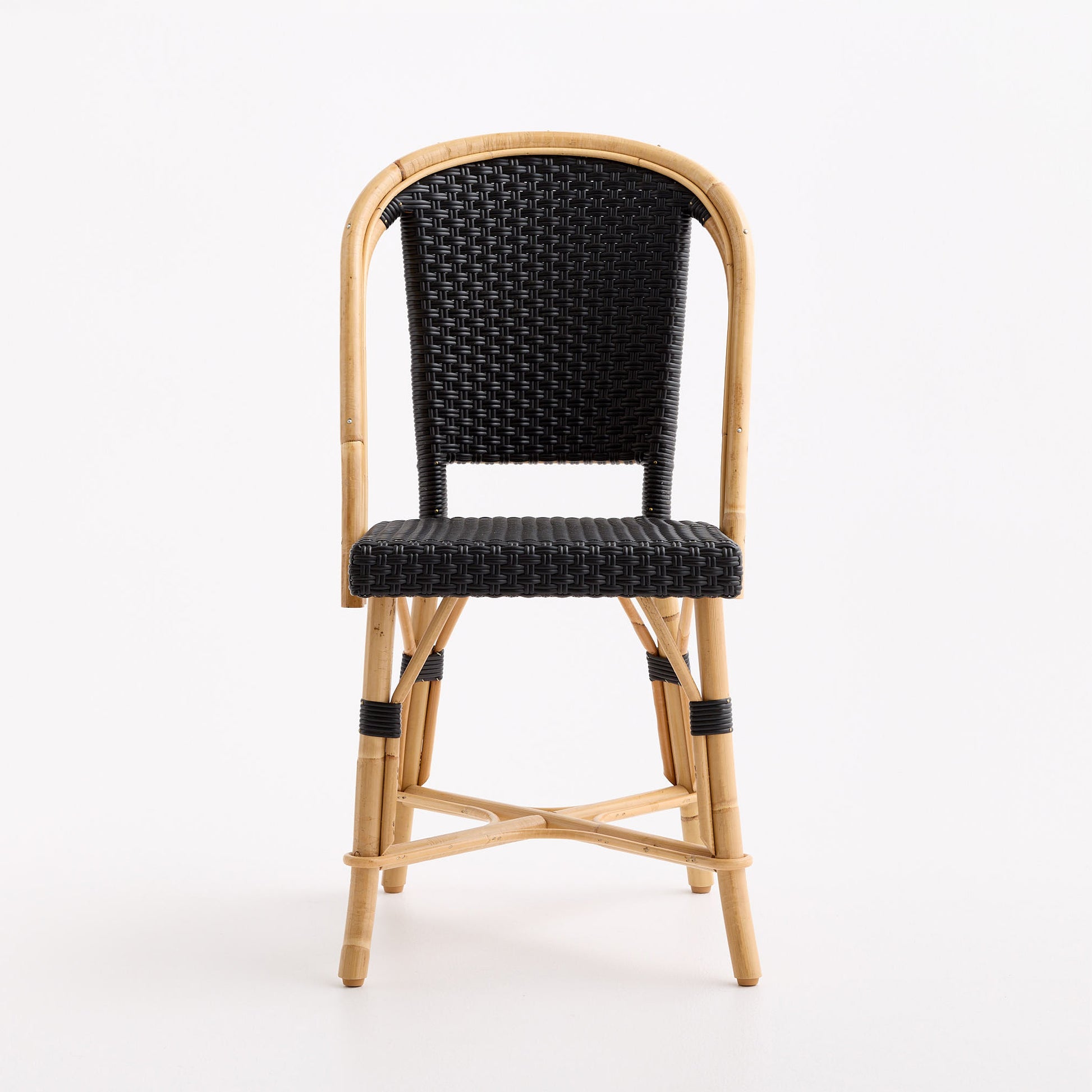 Black woven rattan bistro chair with a natural wooden frame and curved backrest on a white background.