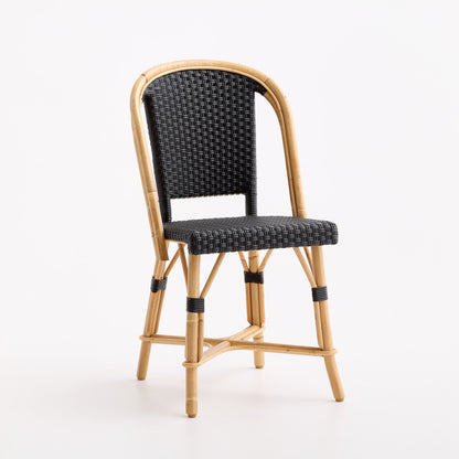 French bistro chair with a natural rattan frame and black woven seat and backrest on a white background.