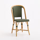 Olive green woven rattan bistro chair with a light wood frame and classic Parisian cafe design.