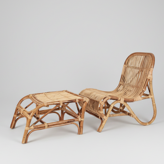 Natural rattan Kim lounge chair with curved back and matching rectangular ottoman.