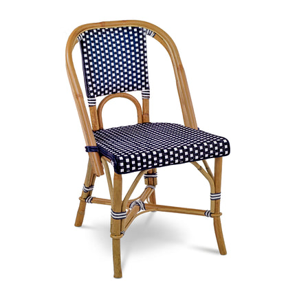 Rattan bistro chair with navy blue and white spotted woven seat and back.