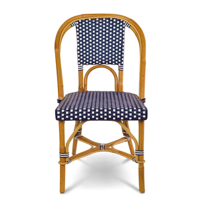 Rattan bistro chair with navy blue and white spotted woven seat and back.