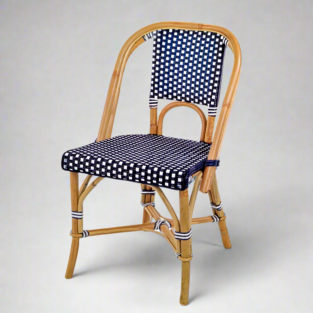 Rattan bistro chair with natural frame, navy blue and white spotted woven seat and back.