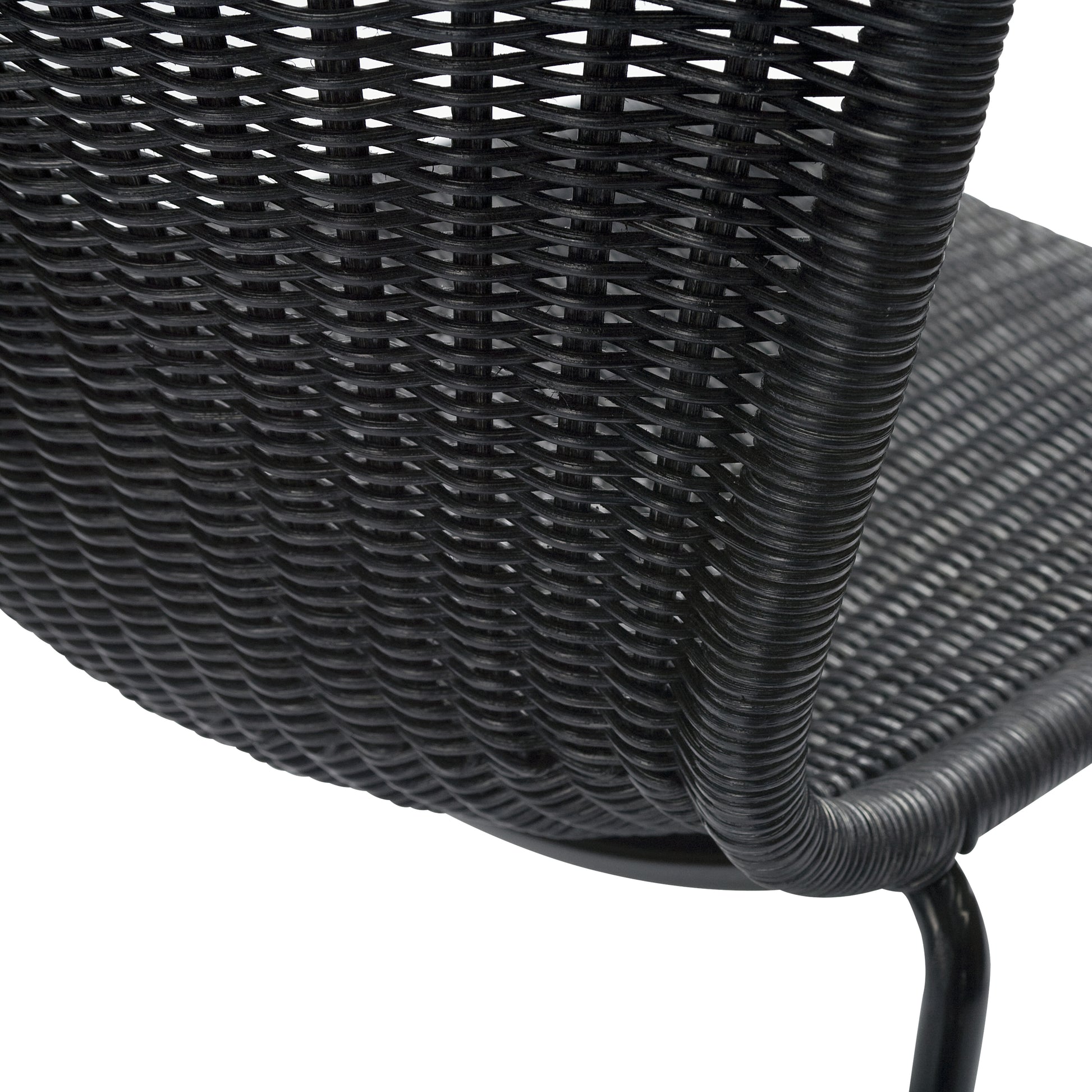 Close-up of a modern black rattan "Wing" dining chair with a woven wicker seat and steel frame.
