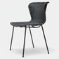 Black rattan "Wing" outdoor dining chair with a sleek, curved back and black steel legs.