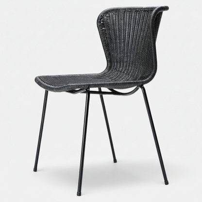 Black rattan "Wing" outdoor dining chair with a sleek, curved back and black steel legs.