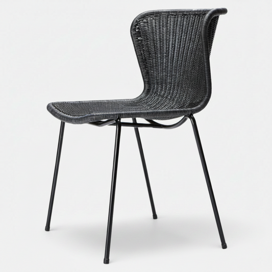 Black rattan "Wing" outdoor dining chair with a sleek, curved back and black steel legs.