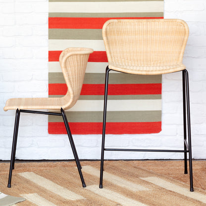 Two Yuzuru Yamakawa Rattan "Wing" outdoor stools, one counter height and one bar height, with black steel frames.