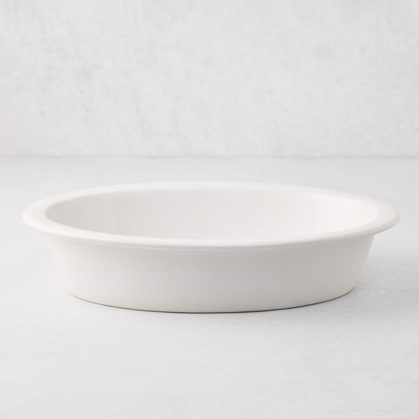 White Ravello stoneware oval baking dish with an oversized lip.