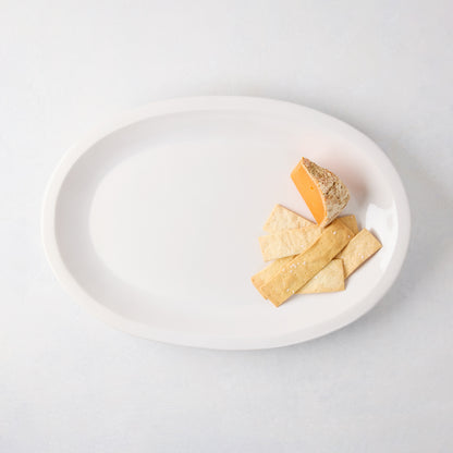 Ravello Small Oval Stoneware Serving Platter in white glaze with cheese and crackers.