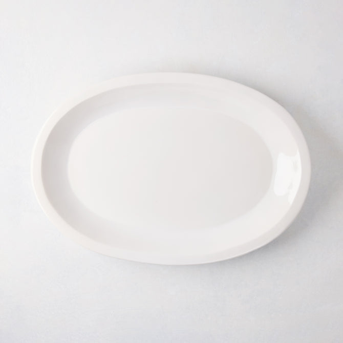 White Ravello Small Oval Stoneware Serving Platter with raised edge, 18.3"L x 12.8"W.