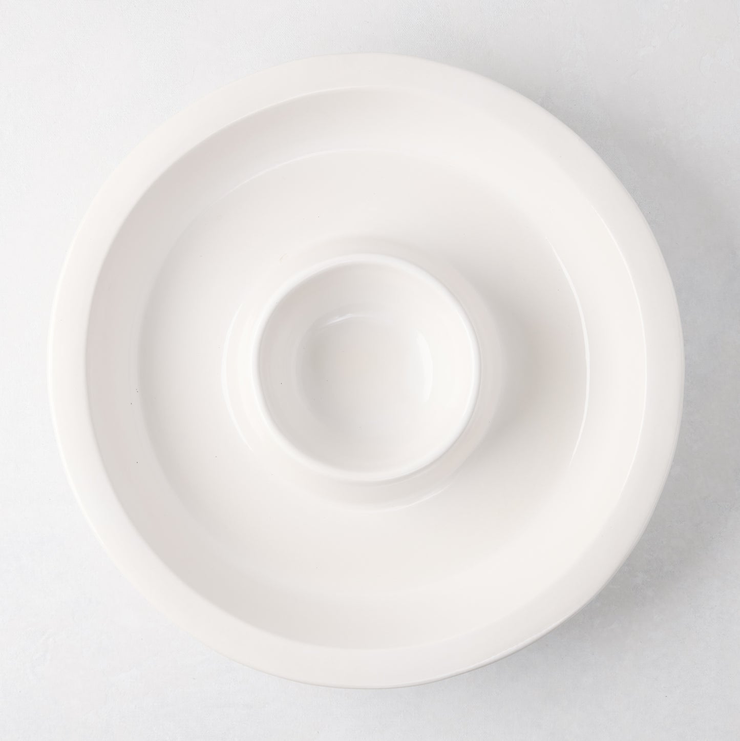 Ravello white stoneware chip and dip platter with built-in dipping bowl, 13" diameter.
