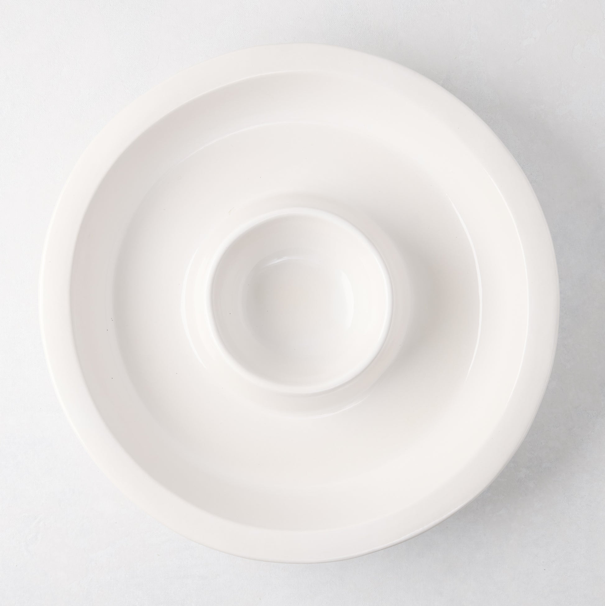 Ravello white stoneware chip and dip platter with built-in dipping bowl, 13" diameter.