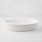 White Ravello stoneware oval baking dish with an oversized lip.