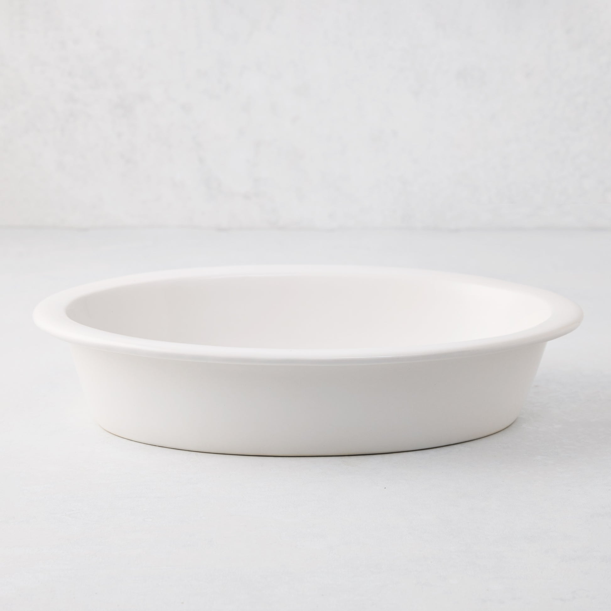 White Ravello stoneware oval baking dish with an oversized lip.