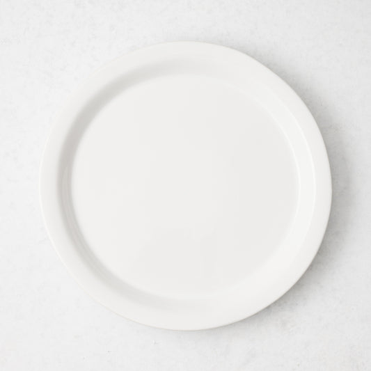 Ravello 8.5-inch white stoneware salad plate with a sleek raised lip, viewed from above.