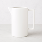 Large rectangular handled ceramic pitcher in creamy white glaze.
