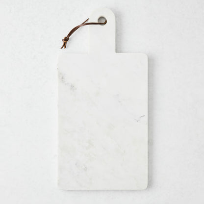 Rectangular white marble serve board with a sleek handle and brown leather strap.