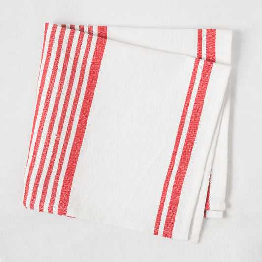 Folded Red Boat Stripe Napkin, 22" square, woven cotton-linen blend with red stripes on ivory.