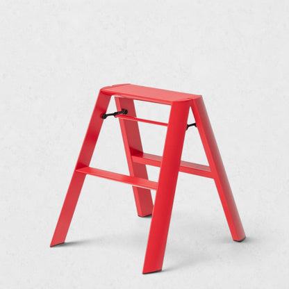 Hudson Grace red Hasegawa Lucano 2-step ladder with a minimalist aluminum and steel design and non-skid feet.