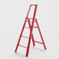 Hudson Grace red Hasegawa Lucano 4-step ladder with a minimalist aluminum and steel design and non-skid feet.