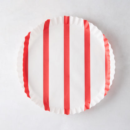 Round white parchment liner with vertical red stripes and ruffled edges.