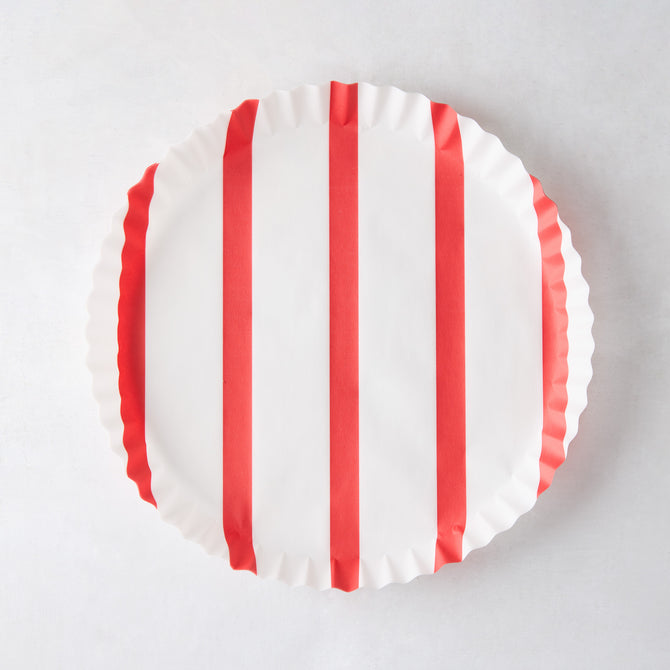 Round white parchment liner with vertical red stripes and ruffled edges.