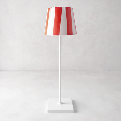 Red and white striped ceramic lamp shade on a white Poldina Pro lamp.