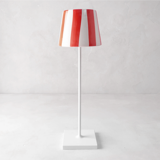 Red and white striped ceramic lamp shade on a white Poldina Pro lamp.
