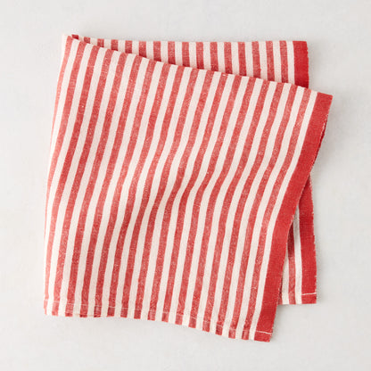 Red Ticking Stripe Linen Napkin, 21" square, with thin red and white stripes and a thicker red border.