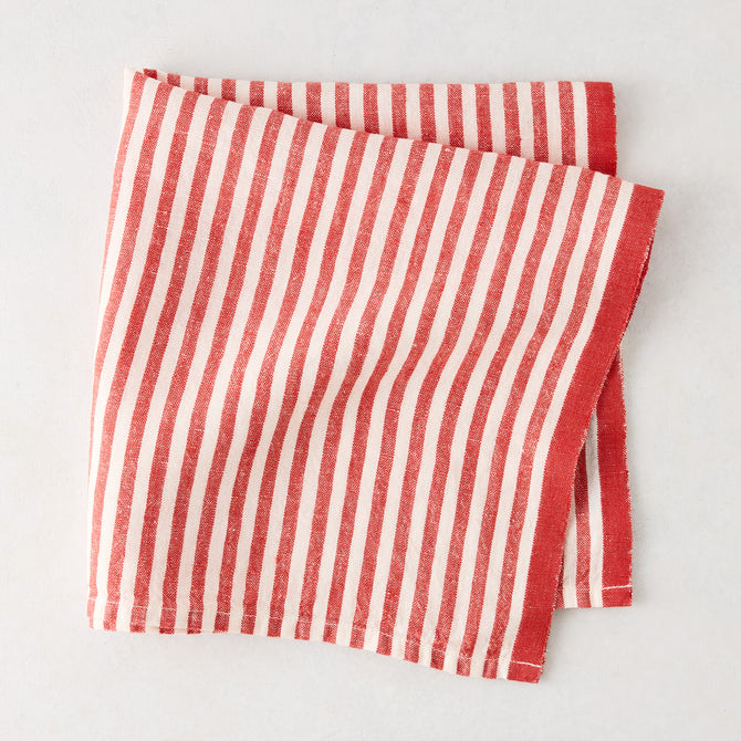 Red Ticking Stripe Linen Napkin, 21" square, with thin red and white stripes and a thicker red border.