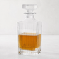 Regent Eco-Crystal Decanter, clear lead-free crystal, square with vertical fluting, partially filled with amber liquid.