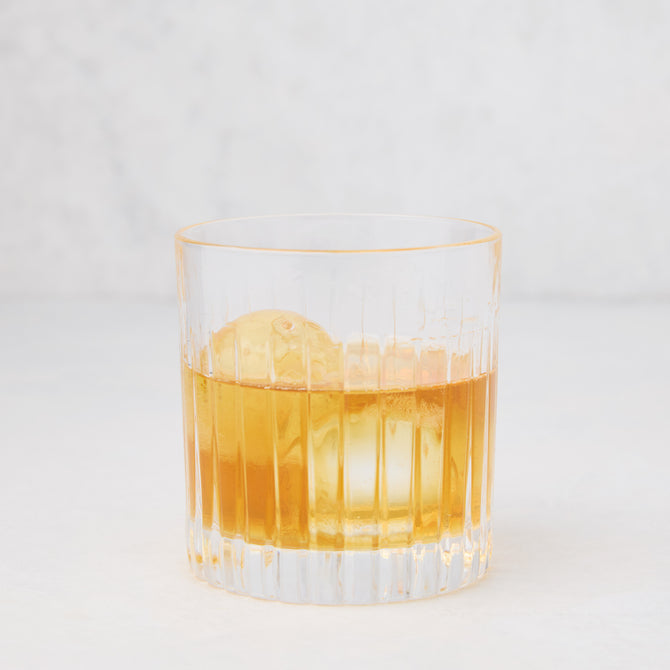 Regent Eco-Crystal Double Old-Fashioned Glass, 11oz, with amber liquid and ice. Clear, ribbed glass.