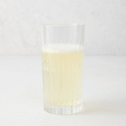 Regent Eco-Crystal High Ball Glass, clear, sleek, slender, with a bubbly light yellow drink.
