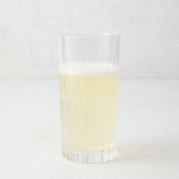 Regent Eco-Crystal High Ball Glass, clear, sleek, slender, with a bubbly light yellow drink.