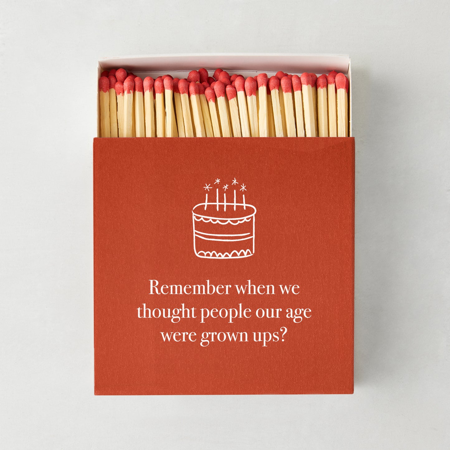 Oversized "Remember When" matches in a red box with a white birthday cake illustration and text.